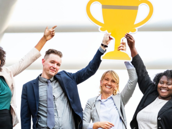 men and women holding trophy best consulting firm