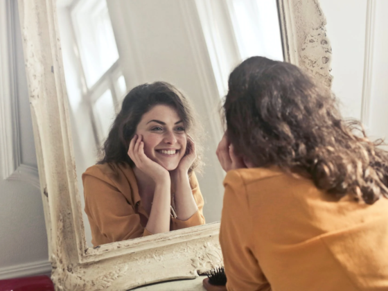 girl smiling at the mirror