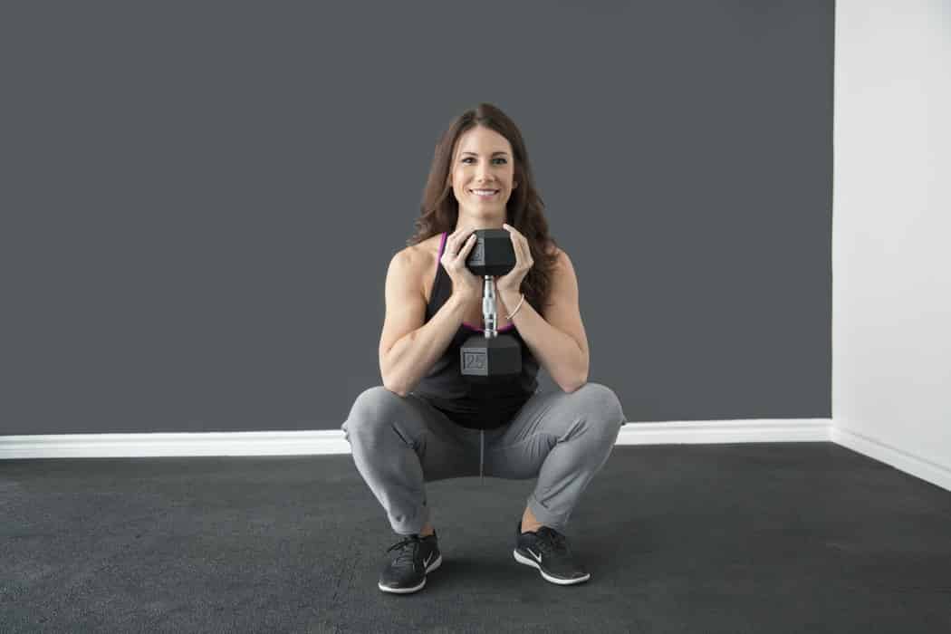 woman squating with weights